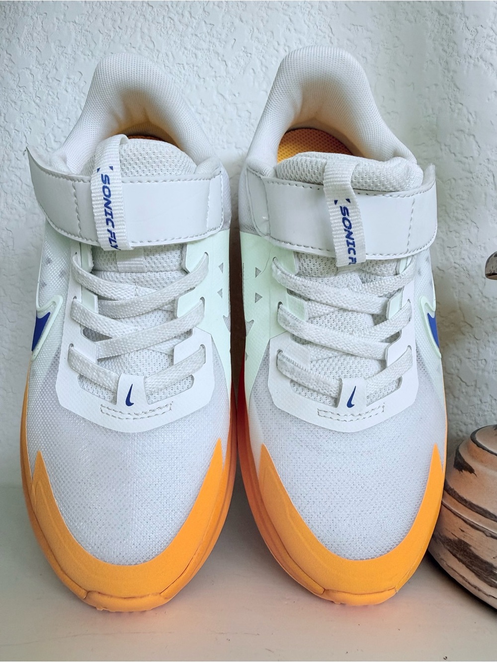 Nike Kids White Sneakers with Orange Toe and Blue Accents